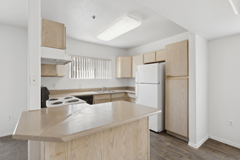 White refrigerator and wooden cabinets in kitchen